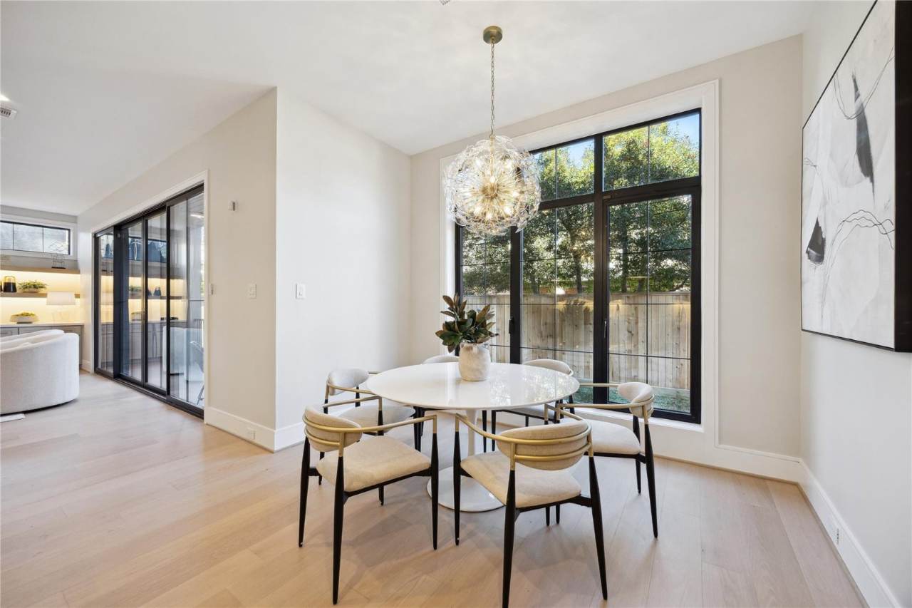 West University Custom Home — Breakfast dining beneath a sculptural glass chandelier